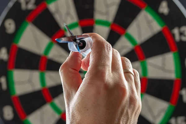 Throwing syringe in the form of a dart with the inscription vaccine hand into a dartboard. Coronavirus vaccine concept. High quality photo