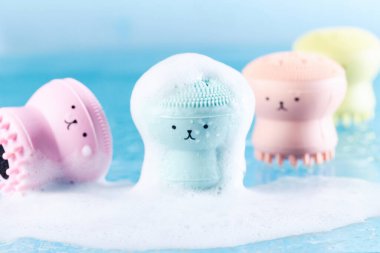 Silikon masaj fırçaları, köpükle kaplı komik yüzleri olan yıkama için. Temizlik ve tazelik, kişisel bakım konsepti