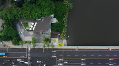 Aerial topdown view of Sanya riverside street traffic, Hainan island, China, 4k 