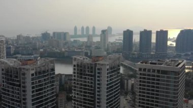 Aerial panorama of riverside bay at Sanya city, sunset time, 4k. Hainan island, China