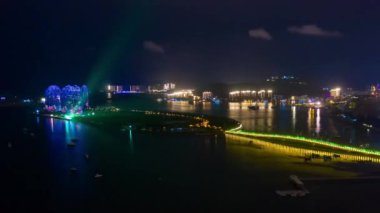 Aerial panorama of illuminated Sanya bay, nighttime, China, time-lapse 4k 