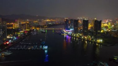 Aerial panorama of illuminated Sanya bay, nighttime, China, time-lapse 4k 