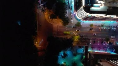 Aerial topdown view of Sanya riverside street traffic, Hainan island, China, 4k 