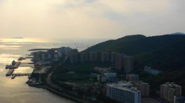 Aerial panorama of Sanya city at sunset time, 4k. Hainan island, China