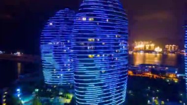 Aerial panorama of illuminated Sanya bay, nighttime, China, time-lapse 4k 