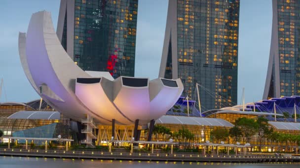薄明かりのシンガポール市内中心部有名なマリーナベイ博物館とホテルモールタイムラプスパノラマ4K — ストック動画