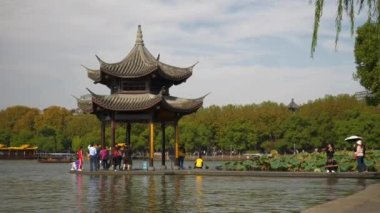 Hangzhou şehri güneşli bir gün ünlü Batı Gölü Körfezi kalabalık rıhtım pagoda ağır çekim panorama 4k porselen