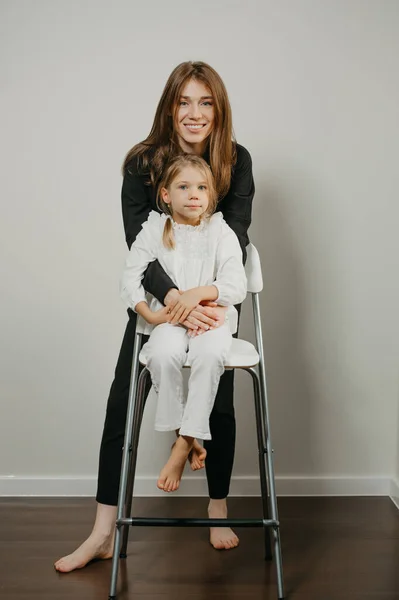 Uma Jovem Mãe Linda Está Abraçando Sua Filha Que Está — Fotografia de Stock