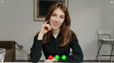 Bir görüntülü konuşma sırasında telekomünikasyon uygulamasının masaüstü bilgisayar ekranı görüntüsü. Kadın ekibin başındaki kişi evdeki iş hakkında bir haber dinliyor..