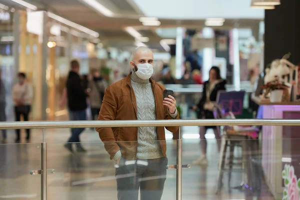 코로나 바이러스가 퍼지는 피하기 마스크를 남자가 센터에서 커피를 있습니다 외과용 — 스톡 사진