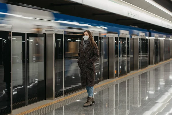 의료용 마스크를 지하철에 열차가 도착하기를 기다리고 코로나 바이러스가 퍼지는 피하기 — 스톡 사진