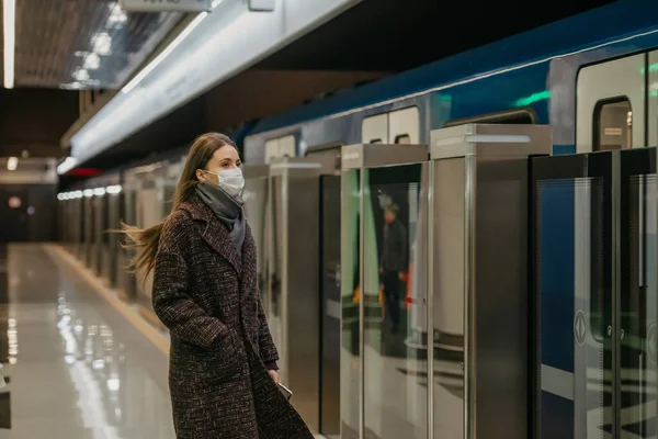 코로나 바이러스가 퍼지지 않도록 의료용 마스크를 현대식 열차가 지하철에 도착하기를 — 스톡 사진