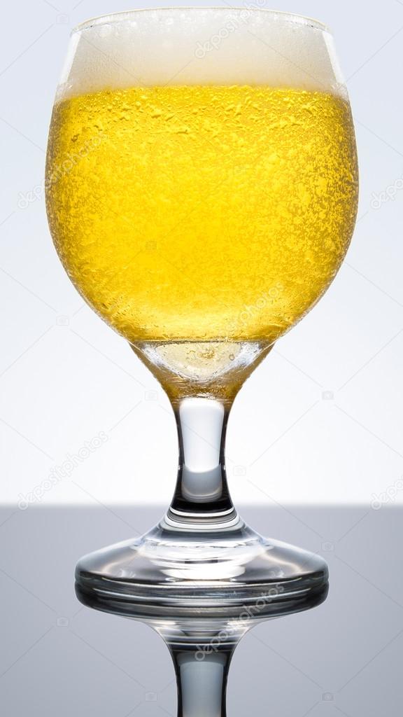 Beer cup on reflective surface