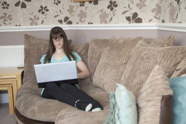 Bir dizüstü bilgisayar kullanarak kanepede döşenmesi