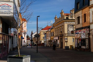 Neo-Renaissance building of the former pharmacy with sgraffito mural decorated plaster in Kladno in sunny day, Narrow picturesque street, Central Bohemia, Czech Republic, December 27, 2020 clipart