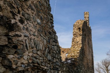 Ortaçağ gotik kalesi Kostomlaty veya Sukoslav kar altında, güneşli kış gününde tepede gri taş yıkıntısı, antik kale, peri masalı kalesi, koruma duvarları, mavi gökyüzü, Çek Cumhuriyeti, 20 Şubat 2021