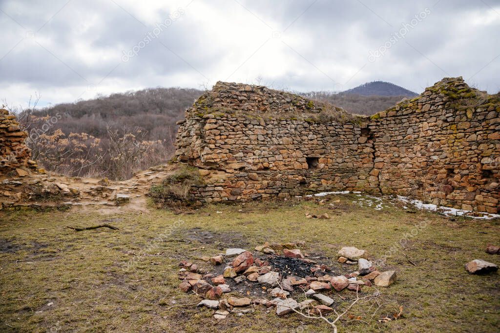 Velemin Oparno, Czech Republic, 27 February 2021: Stone gothic ruins of old medieval castle Oparno, ancient fortress in winter day, landmark in countryside, stronghold on the hill.