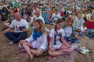 People meditating in a city park