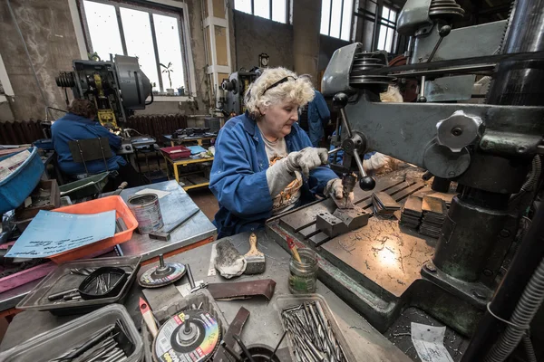 Mujer trabajando en una máquina de perforación — Foto de Stock