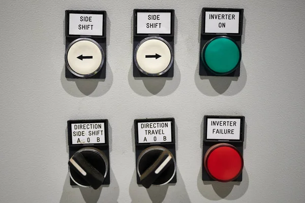 Part of the instrument panel of an industrial machine tool with control buttons - side shift, inverter on, direction side shift, direction travel, inverter failure