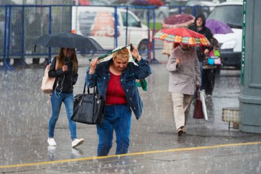 St. Petersburg, Rusya - 24 Temmuz 2017: Şiddetli bir yağmur sırasında sokakta şemsiye altında yayalar. Islak asfalt, insanların acelesi var.