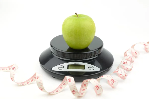 Black digital scale, weight green apple — Stock Photo, Image