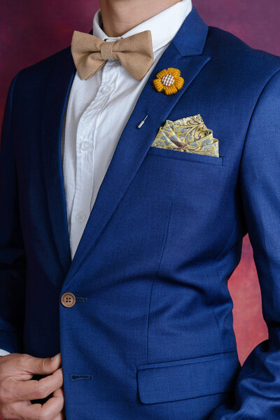 man in blue suit bowtie, pocket square