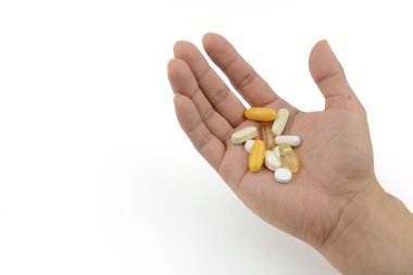 Many medicine and vitamin carried in hand  clipart