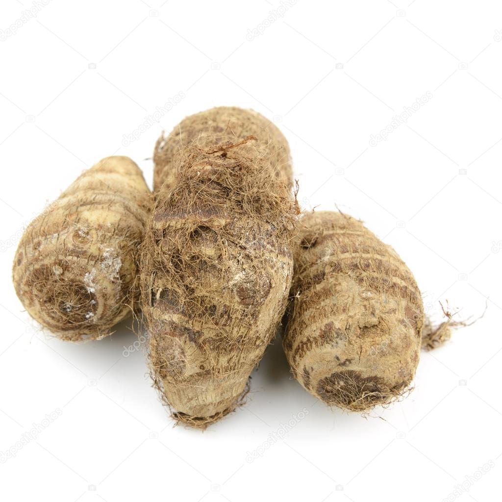 Raw taro with root on white background