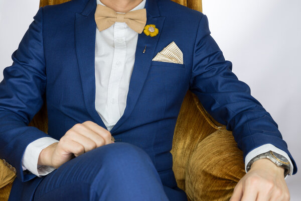man blue suit sitting on cozy sofa