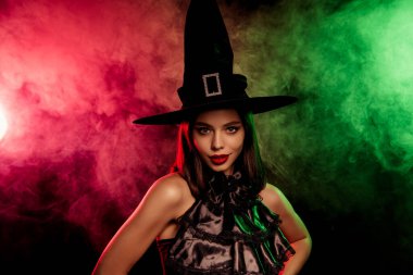 A stylish witch in radiant fog evokes Halloween magic. Her charm blends fashion with an enchanting allure, perfect for festive celebrations.