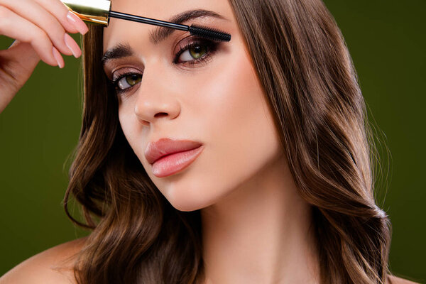 Close-up of a woman enhancing her eyelashes with a makeup tool, showcasing beauty, femininity, and cosmetics. Suitable for themes of personal care, beauty products, and fashion imagery.