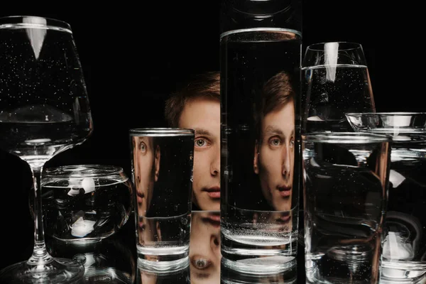 Szürreális portré egy férfiról, aki egy pohár vízen keresztül néz. — Stock Fotó