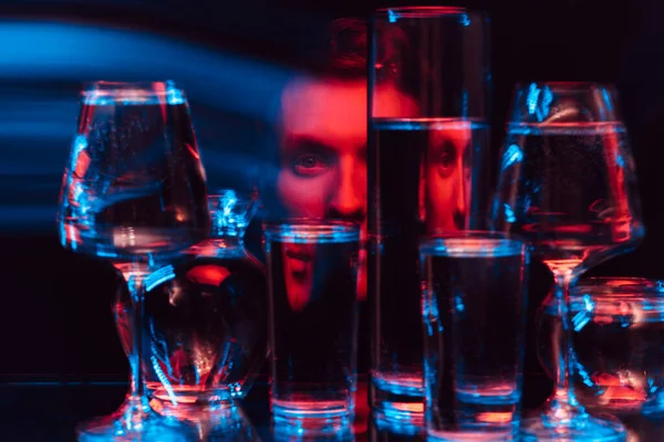 Psykedeliskt surrealistiskt porträtt av en man genom glas vatten med suddighet — Stockfoto