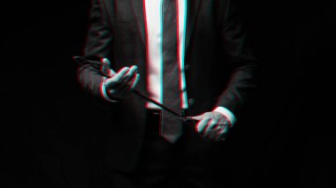 Male dominant businessman in a suit holding a leather whip Flogger for domination clipart