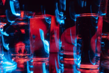 Bulanık bardaklarla suya bakan bir adamın tuhaf portresi.