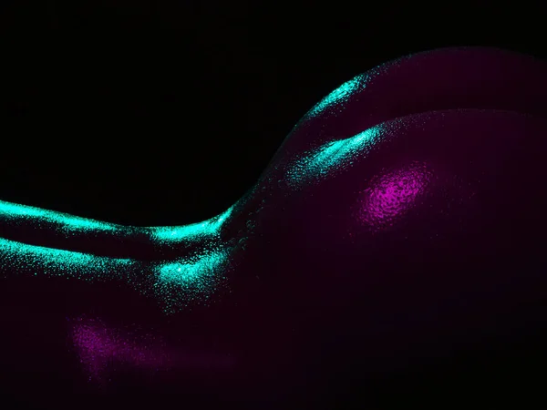 Sexy ass of a girl in wet drops. Female buttocks in neon light — Stockfoto