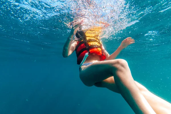 Corpo delle donne in un giubbotto di salvataggio galleggia sott'acqua in mare — Foto Stock