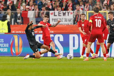 Sarpreet Singh and Kacper Kozlowski seen  during International friendly game between national teams of Poland and  New Zealand (Maciej Rogowski/Ball Raw Images)