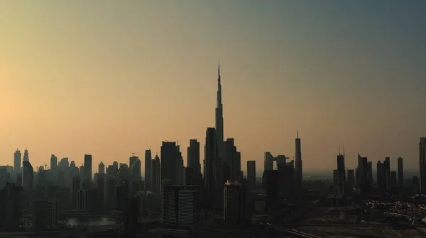 Vista panoramica sul tramonto aereo di una grande città moderna timelapse, grattacieli, edifici per uffici e burj al arab silhouette sullo sfondo. Business bay, Dubai, Emirati Arabi Uniti. — Foto Stock