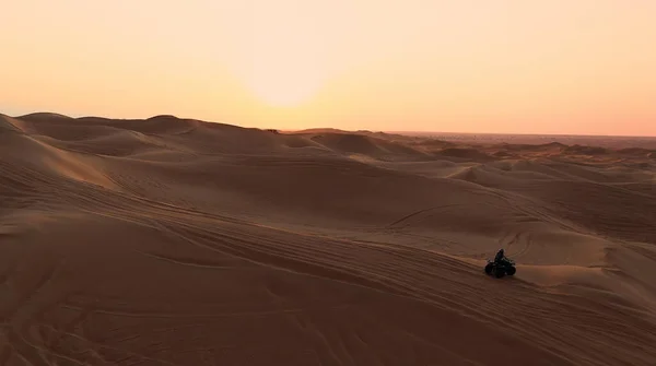 AERIAL. ATV travelling in sand desert. — Stock Photo, Image