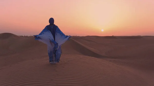 Πορτρέτο της όμορφης αραβικής γυναίκας φορούσε μπλε παραδοσιακό φόρεμα στην έρημο κατά τη διάρκεια του ηλιοβασιλέματος. — Φωτογραφία Αρχείου