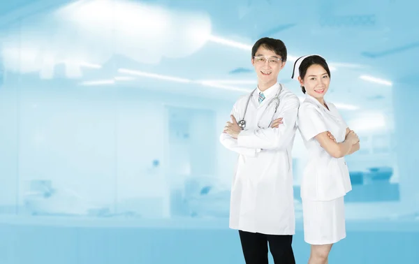 Portrait of male doctor and female nurse in uniform standing and smiling include path — Stock Photo, Image