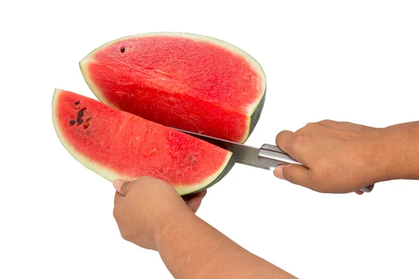 Use a knife to cut the watermelon into pieces — Stock Photo, Image