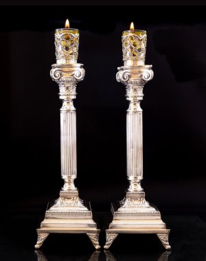 Shabbat candles. Silver candlesticks with olive oil clipart