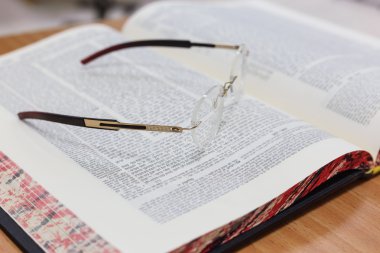Glasses on the Talmud. Background Torah study clipart