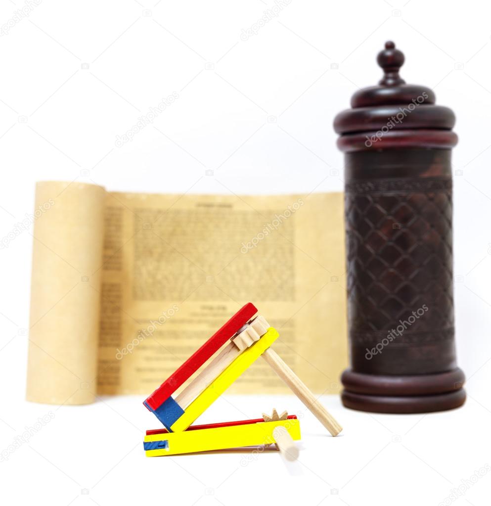 Colorful wooden noisemaker with Megillah Purim holiday background