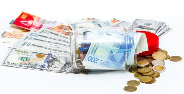 Glass jar of pile of New Israeli Shekels banknotes with the new 200 NIS and Pile of dollars — Stock Photo, Image