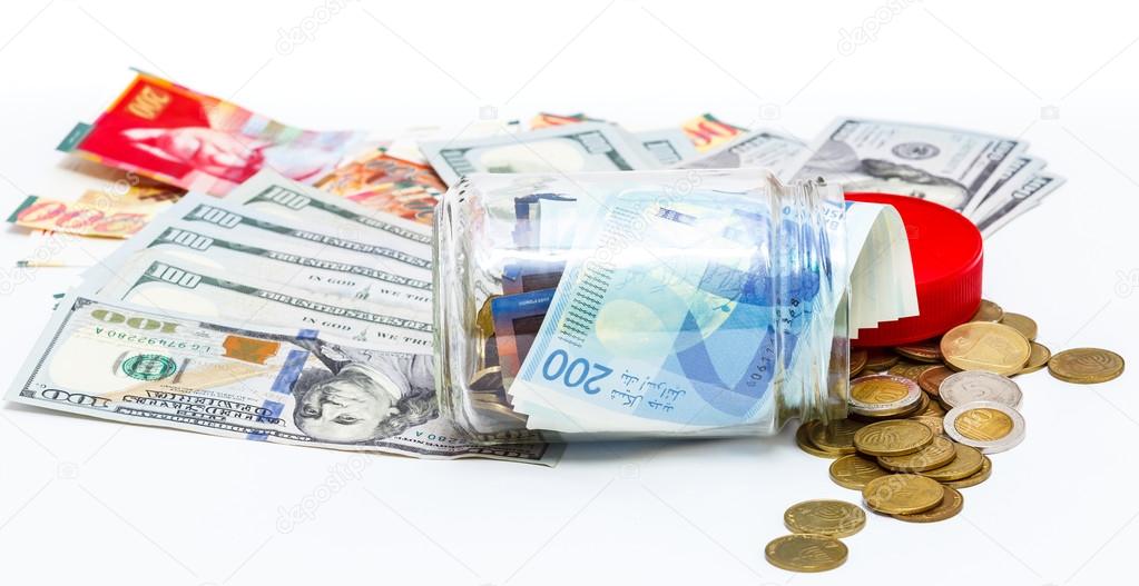 glass jar of pile of New Israeli Shekels banknotes with the new 200 NIS and Pile of dollars