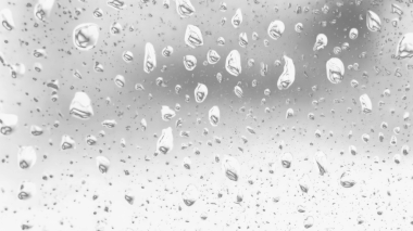 Islak cam. Su damlacıkları. Kapalı camlara yağmur damlaları düşer. Seçici odak siyah ve beyaz